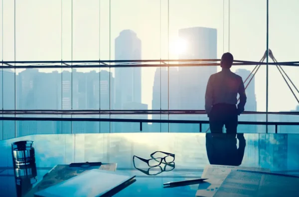 businessman looking outside the building windows