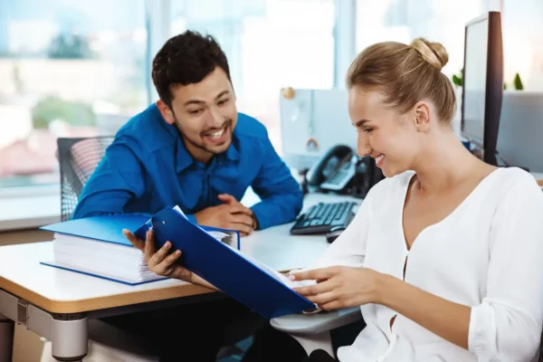 Happy dentist and accountant looking at papers