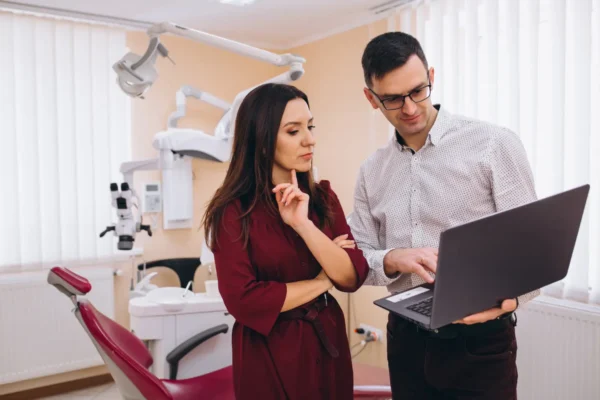 Dentist and accountant looking at a laptop