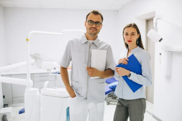 dentist and accountant holding papers