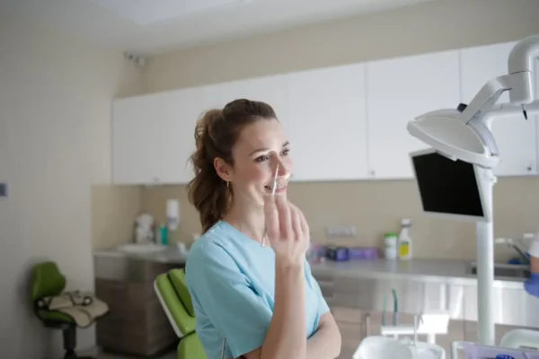 happy dentist holding an injection