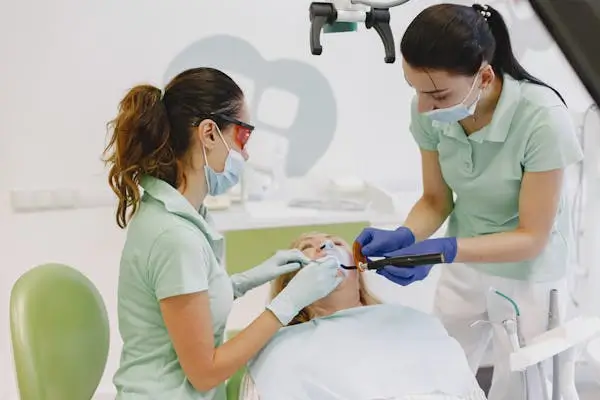 two dentists doing dental work on a patient